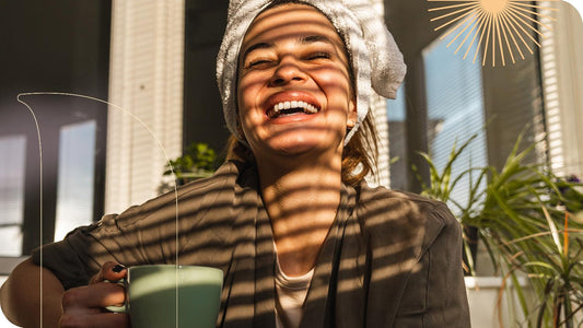 Mulher com toalha na cabeça, tomando sol em uma manhã de inverno e bebendo chá.